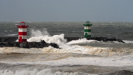 stormy waves crashing against breakwater with lighthouses