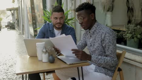 focused freelancers working together in outdoor cafe