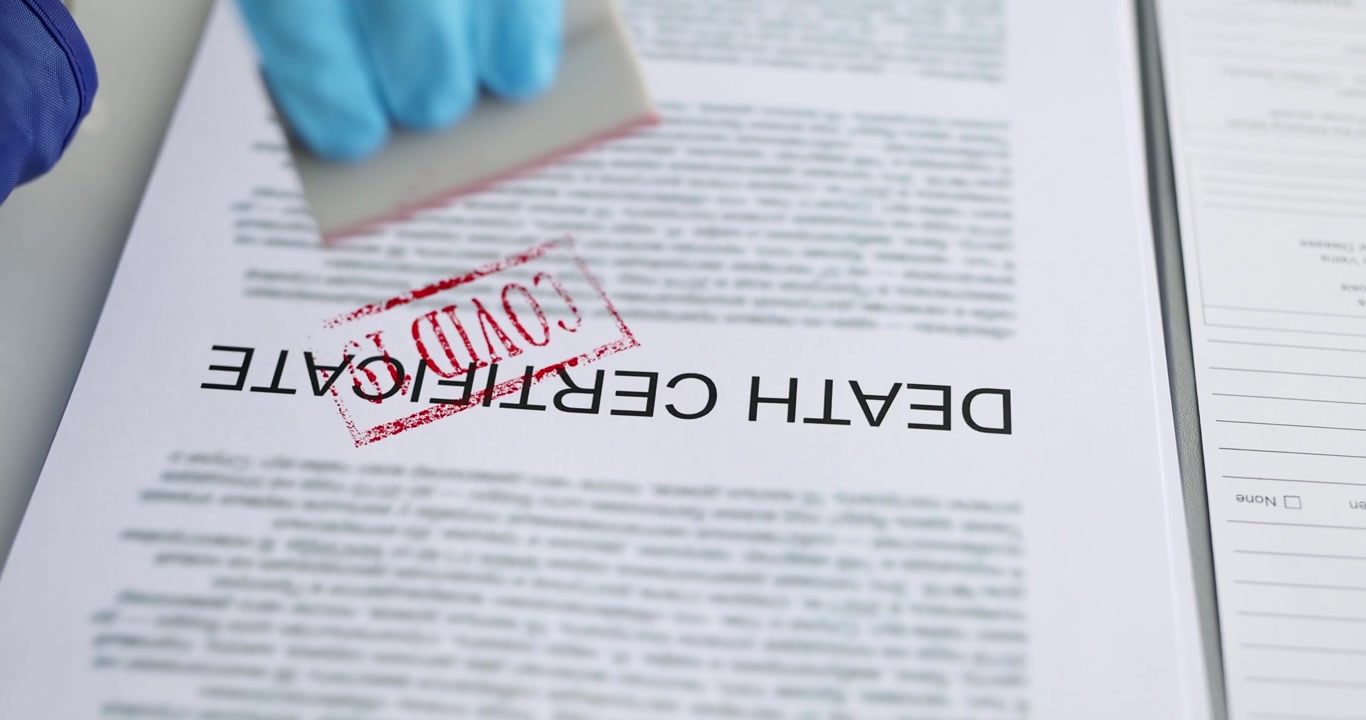 A death certificate document with a pen set on a professional desk for record keeping