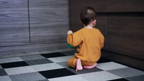 toddler playing in the kitchen