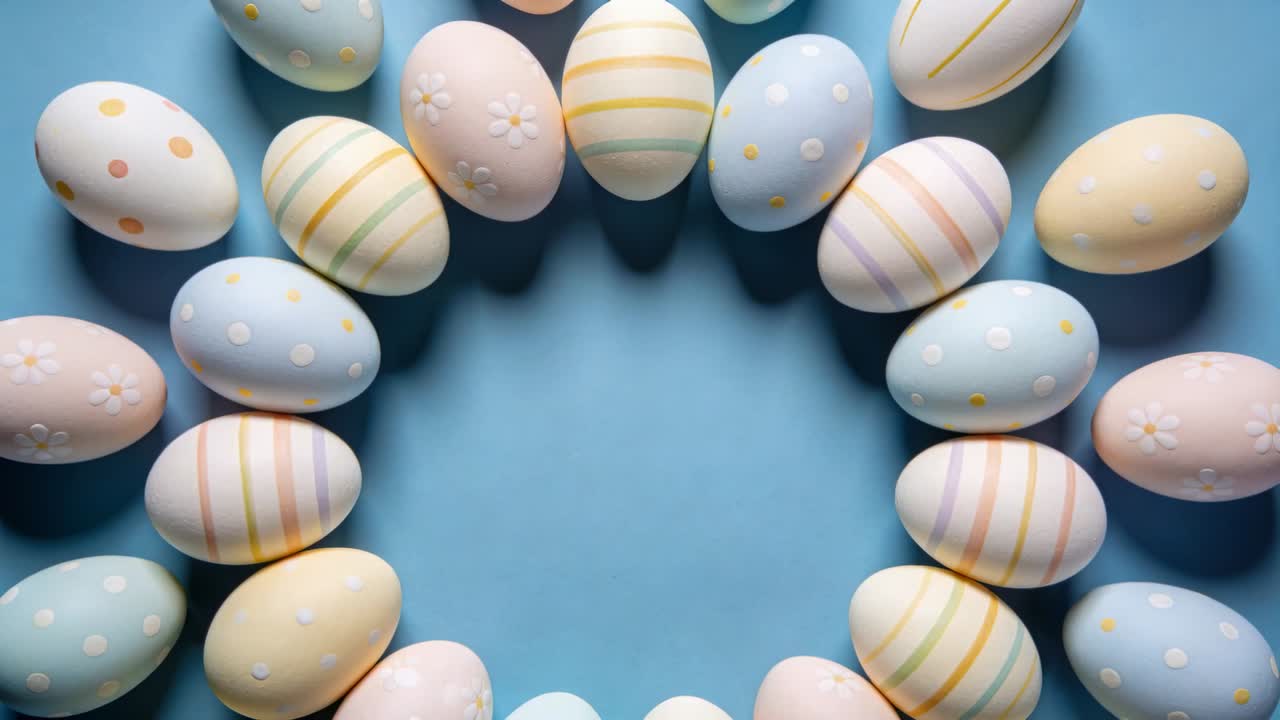 At start, wreath of pastel eggs rotating clockwise and shifting on blue paper, revealing patterns