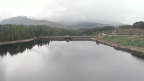 flying backwards looking at laggan dam, located on the river spean south west of loch laggan in the scottish highlands