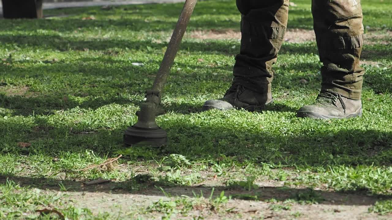 Person mowing lawn with lawnmower
