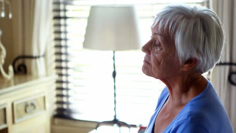 tensed woman sitting on bed in bedroom