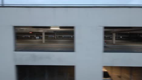 drone shot of a car driving in a multi-storey carpark