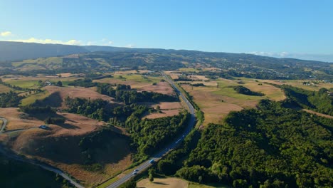 aerial drone landscape fly above chiloe open fields in patagonian chilean travel destination, environmental scene, roads drive through meadow highway