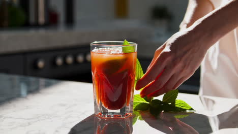 woman preparing a refreshing summer cocktail