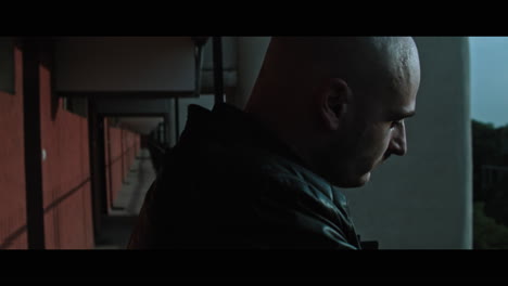 a bald gang member on guard
