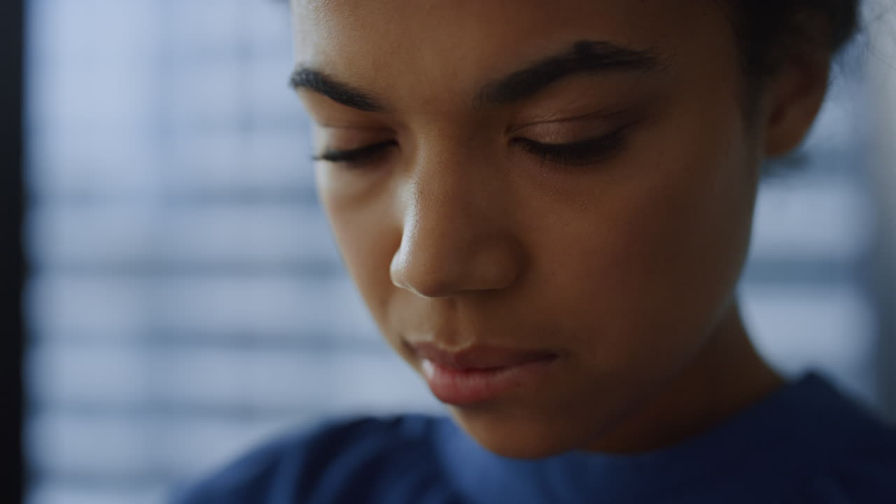 African woman face closeup.. Thoughtful businesswoman using smartphone