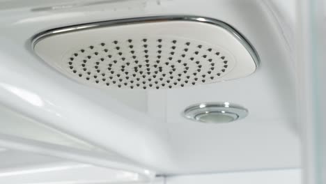 hand touching a modern shower head