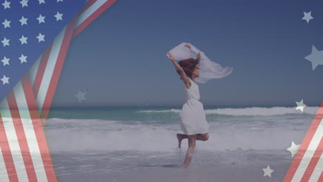 animation of american flag over african american woman raising hands at beach