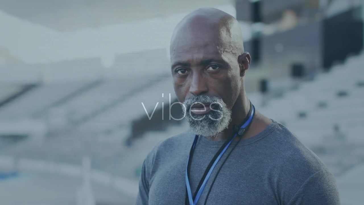 Animation of interference and vibes text over senior african american male sports coach