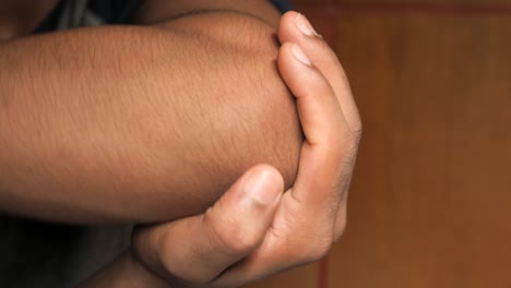 close up of a person checking their elbow.