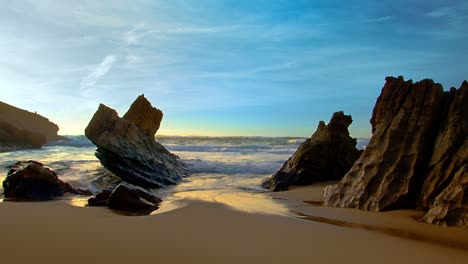 ocean waves splashing crash flow on rocky volcanic atlantic beach during epic scenic sunset wide shot