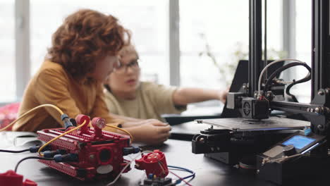 two intelligent schoolchildren programming robot using laptop