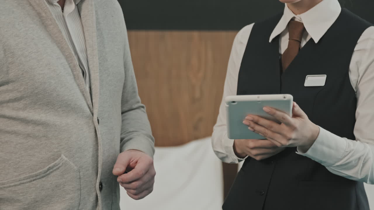 Man Registering in Hotel Room