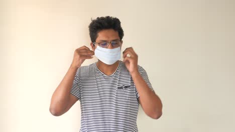 man putting on a face mask