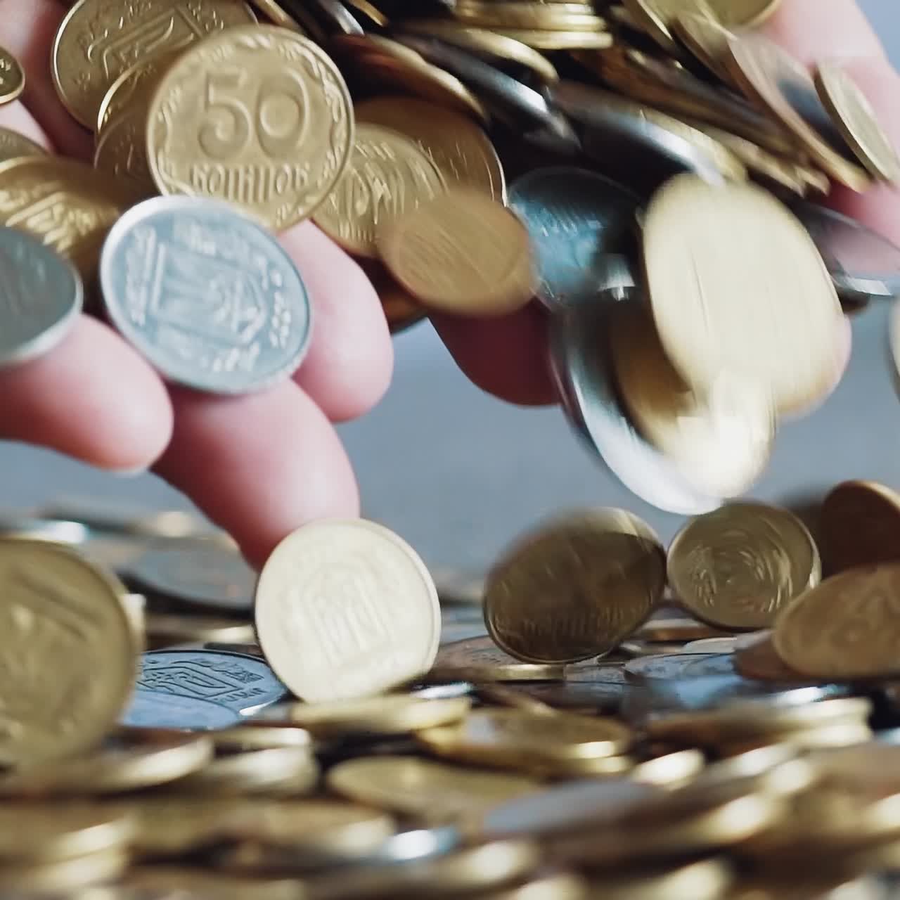 Lot of coins in the hands of men. Slow motion