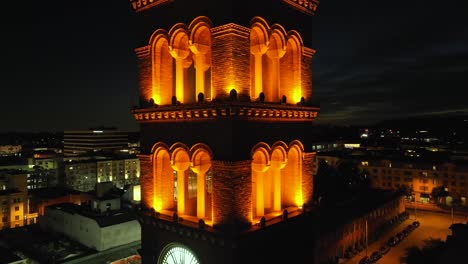 clock and bell tower church overlooking pasadena - ascending aerial view at night, establishing shot