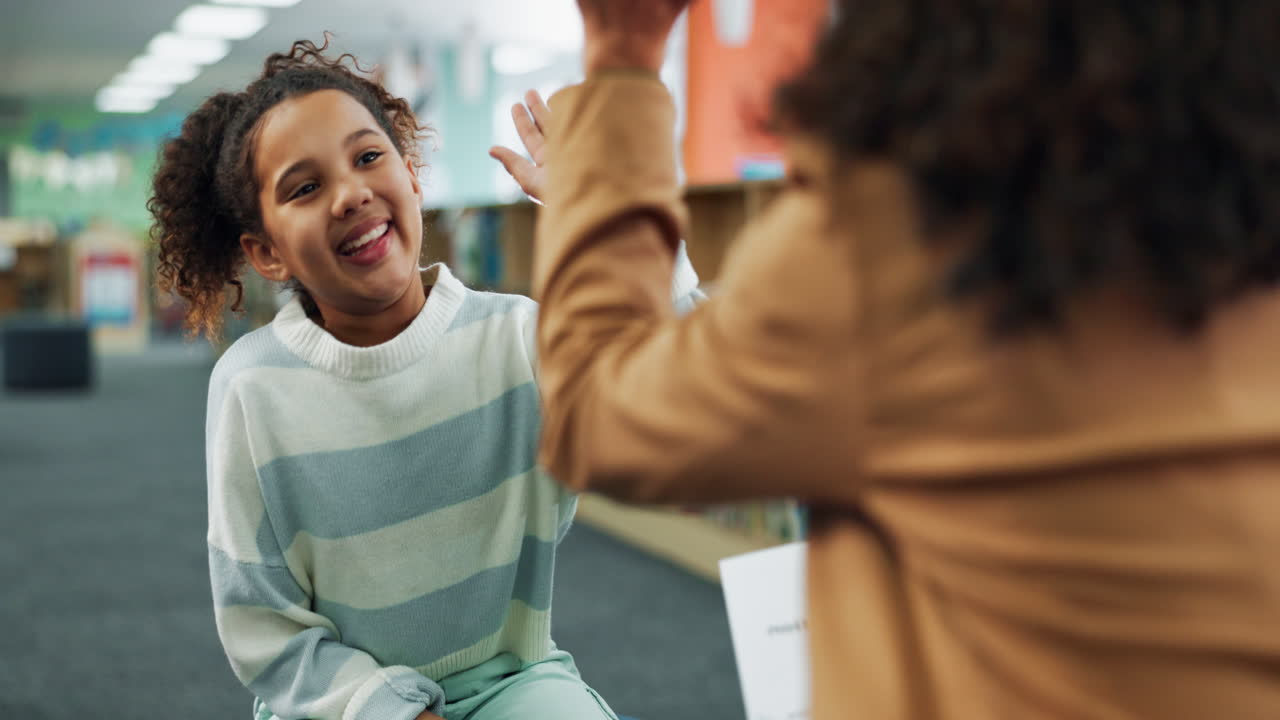 Girl giving high five in library