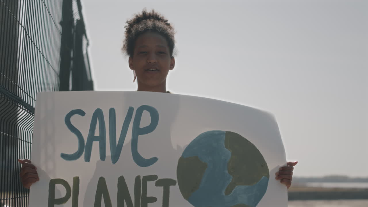 Black Girl Protesting with Save Planet Poster