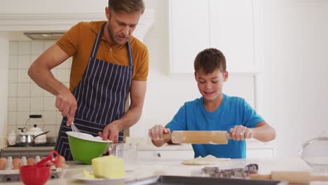 Caucasian-father-and-son-baking-together-in-the-kitchen-at-home