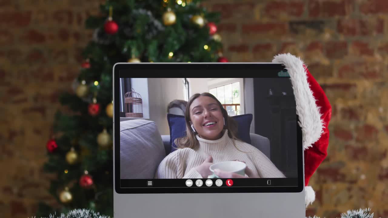 mujer caucásica feliz en videollamada en computadora portátil, con decoraciones de navidad y árbol