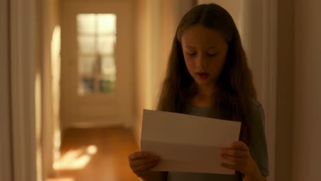 girl reading letter in hallway