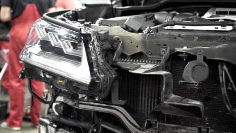 damaged suv front end in repair shop