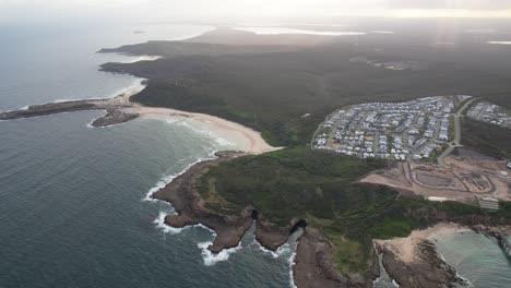 moonee beach and hales bluff in catherine hill bay, new south wales, australia - aerial shot
