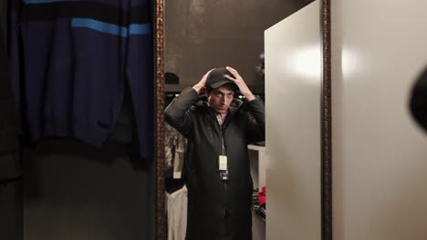 man trying on clothes in a fitting room