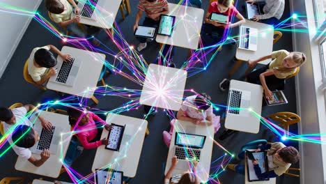 students in a classroom learning with digital devices