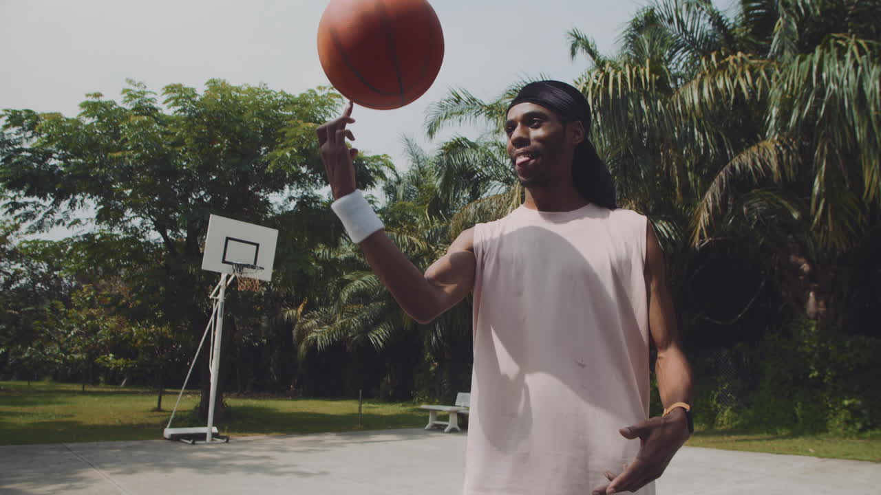 Slowmo of Black Sportsman Bouncing Ball off Floor