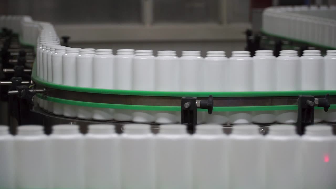 Plastic Bottles on a Conveyor Belt in a Manufacturing Plant