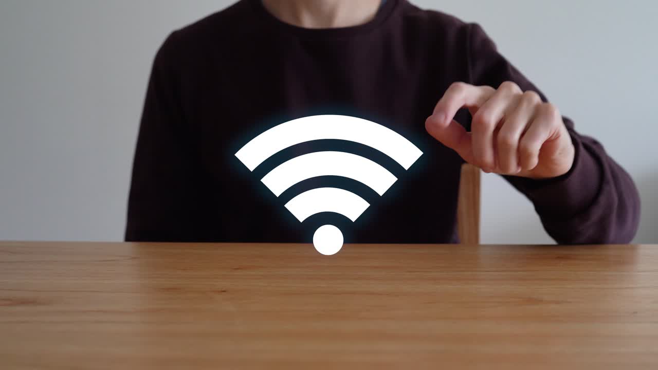 Person Sits At Wooden Table, Touches Wi-Fi Icon to Make It Vanish. closeup shot