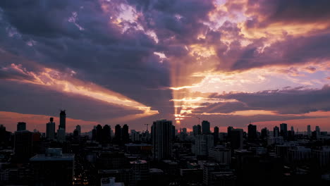 dramatic sunset over city skyline with sun rays