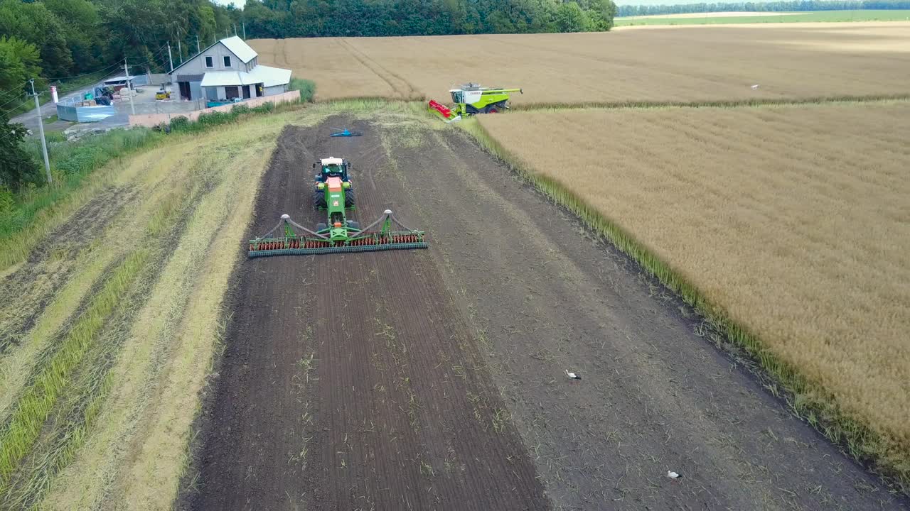 Plow Attached To A Tractor On A Field. VINNITSA, UKRAINE - JULY 2017: Modern farming tractor which plowing agriculturafield