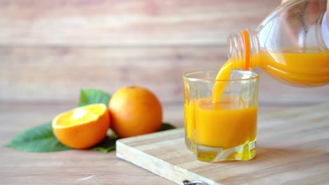 pouring orange juice into a glass