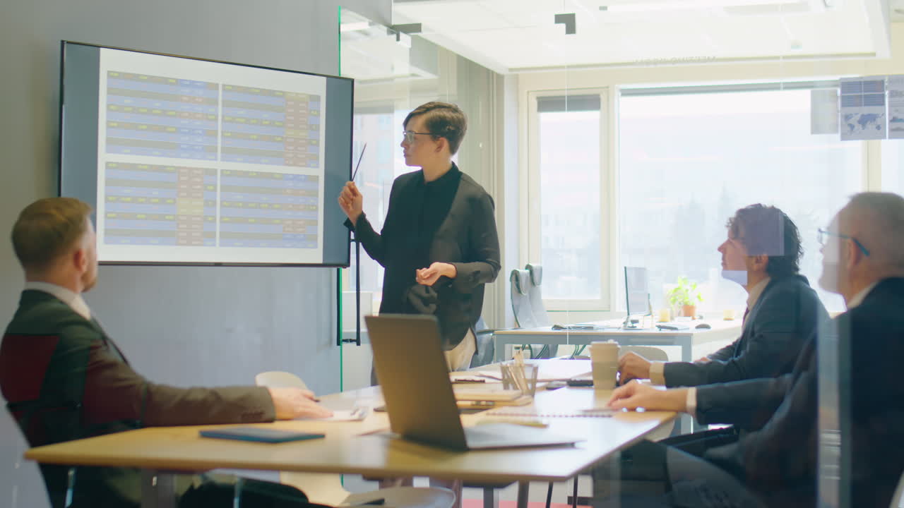 Businesswoman Giving Presentation to Team of Colleagues