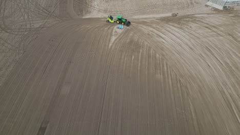 surf rake pulled by tractor combing sand dunes