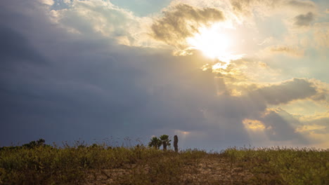 low angle timelapse looking at the sky the sun peaking through rain clouds