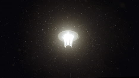 a lantern lighting up the snow around it during a cold blizzard at night