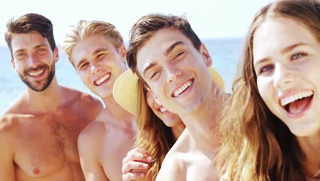 portrait of happy friends having fun at beach