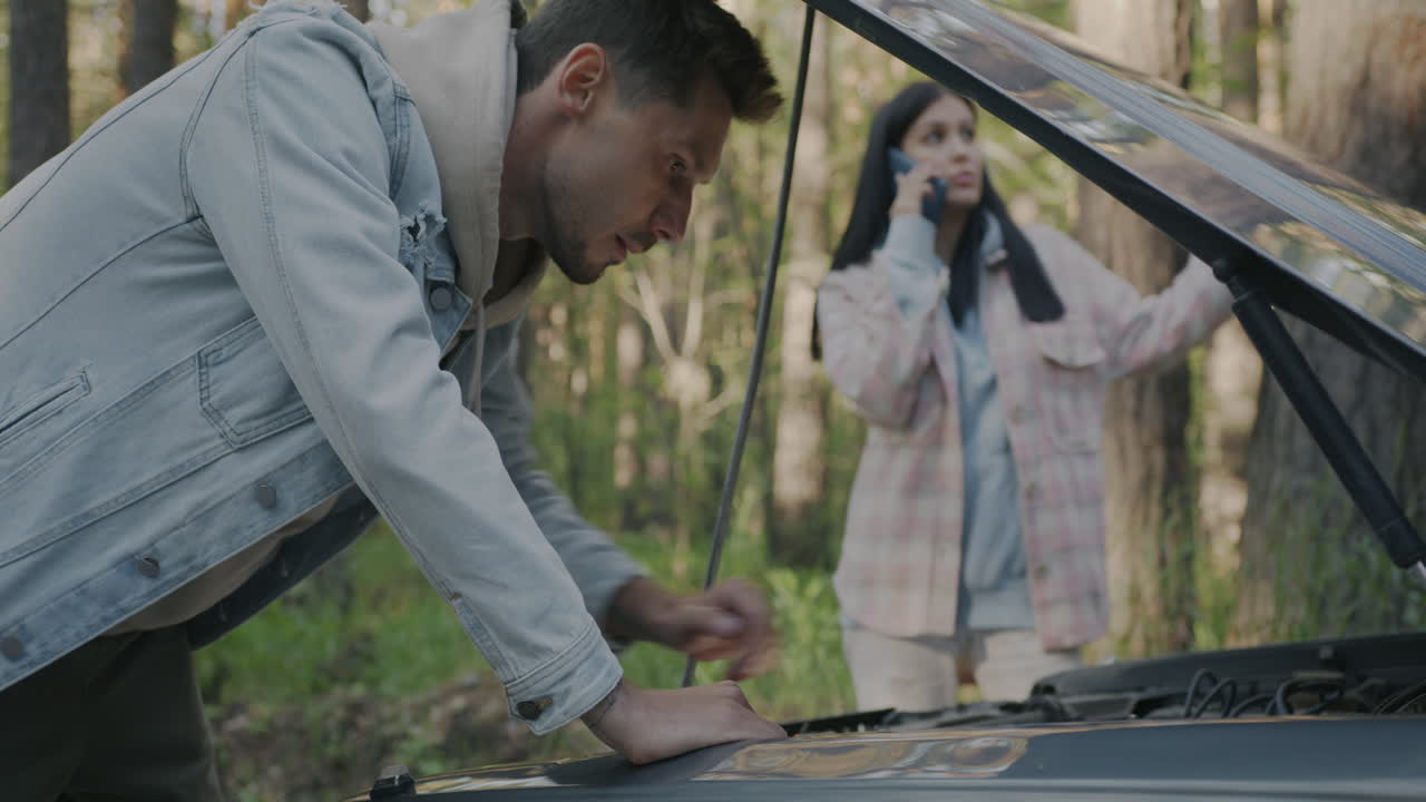 Couple with Car Trouble in the Forest