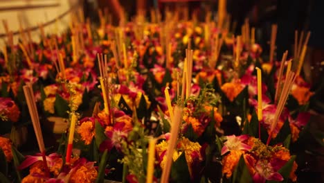 closeup of beautiful loy krothong flowers in baskets on the stand for sale on the night market for the loy krathong festival in bangkok, thailand, asia