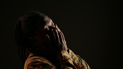 Lazy-male-model-feeling-sleepy-on-black-background