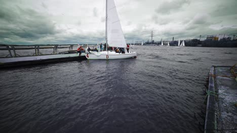 sailing competition on a lake with cloudy weather