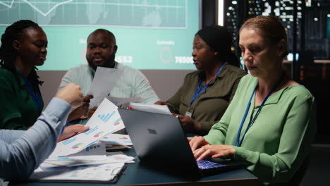 female supervisor and her staff members reviewing efficiency metrics