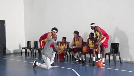 basketball coach motivating team during intense strategy session on court