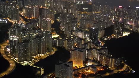 a breathtaking drone view of hong kong at night, showcasing the glowing skyline, busy harbor, and vibrant city lights from above.